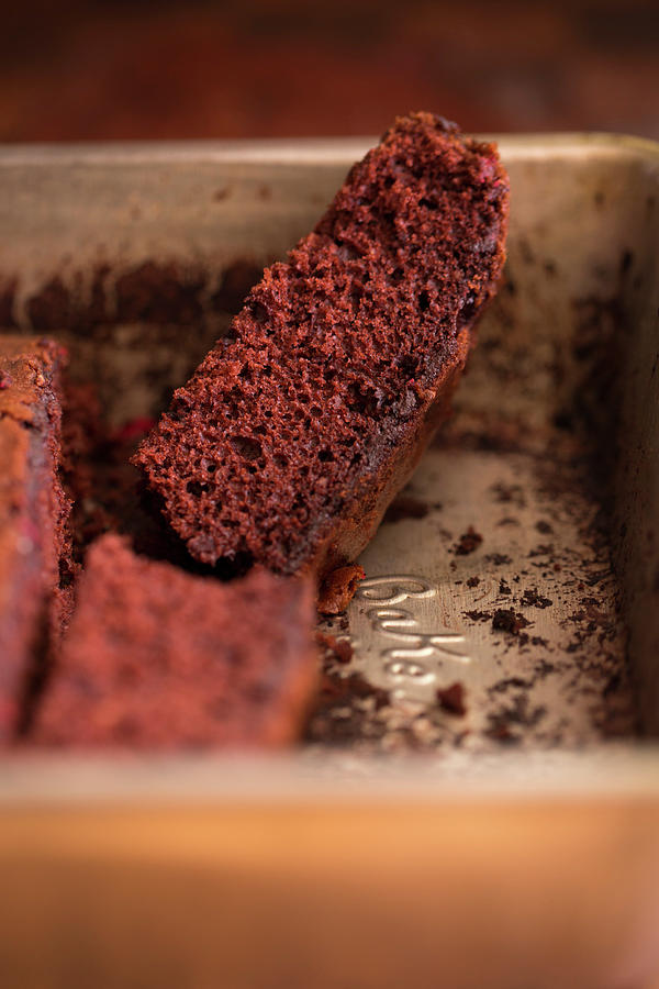 A Slice Of Chocolate Cake In A Baking Tin Photograph by Eising Studio