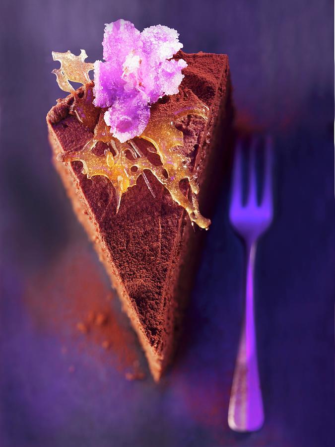 A Slice Of Chocolate Layer Cake With Caramel And Candied Flowers Photograph by Urban, Martina