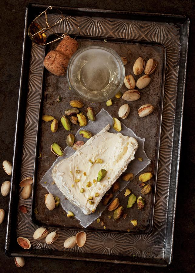 A Slice Of Delice De Bourgogne Soft Cheese Served With Pistachio Nuts And Champagne Photograph by Jane Saunders