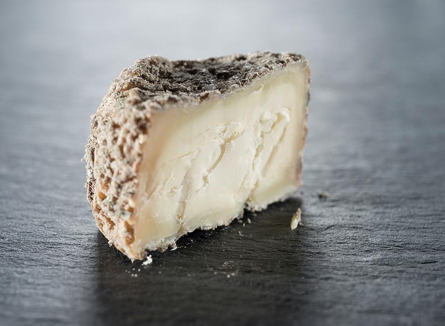 Cheese Photograph - A Slice Of Goats Cheese On A Slate Surface by Gaelle Ap