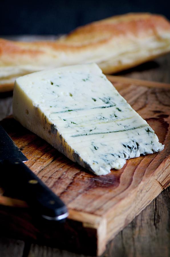 A Slice Of Gorgonzola On A Wooden Board With A Baguette And A Knife Photograph by Jamie Watson
