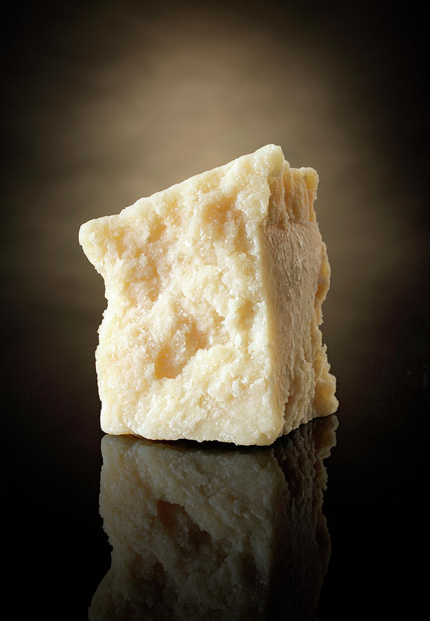 A Slice Of Parmesan Against A Dark Background Photograph by Petr Gross