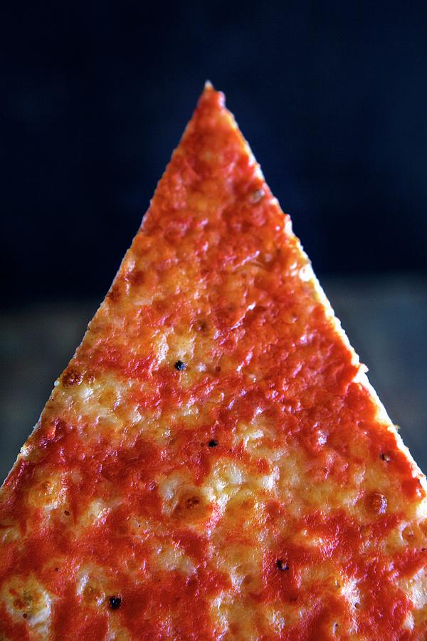 A Slice Of Pizza In Front Of A Dark Background close-up Photograph by Andre Baranowski