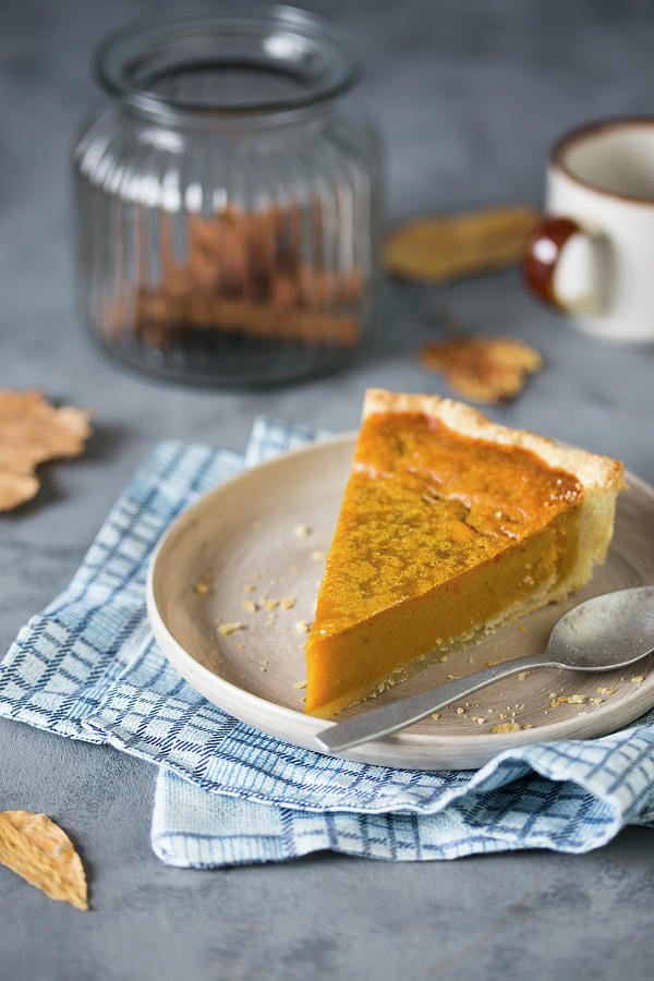 A Slice Of Pumpkin Pie On A Plate With A Spoon Photograph by Malgorzata Laniak