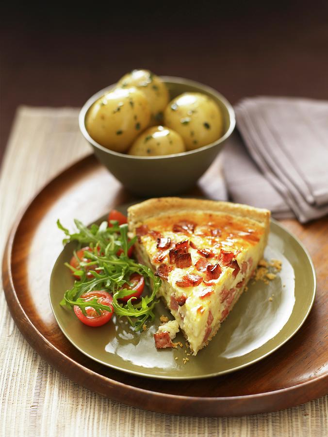 A Slice Of Quiche Lorraine With Rocket Salad And A Side Dish Of Potatoes Photograph by West, Stuart