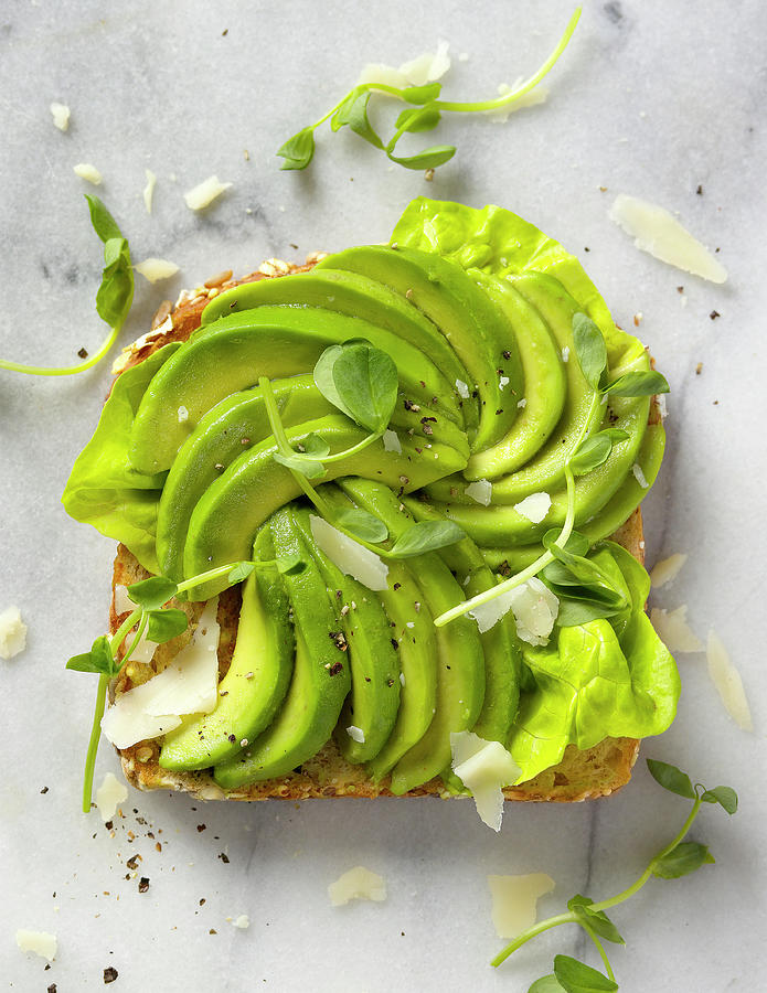 A Slice Of Toast Topped With Avocado Wedges seen From Above Photograph by Janellephoto