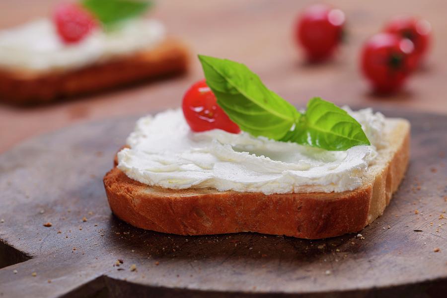 A Slice Of Toast Topped With Cream Cheese, Tomato And Basil Photograph by Frank Weymann