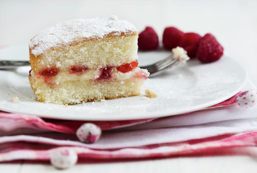 A Slice Of Victoria Sandwich Cake With Raspberries Photograph by Cath Lowe