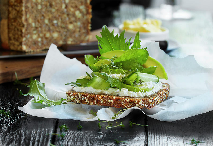 A Slice Of Wholemeal Bread With Ricotta And Avocado Photograph by Sven C. Raben