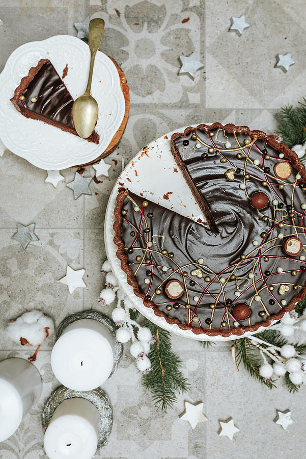 A Sliced Chocolate Cake On A Table Decorated For Christmas seen From Above Photograph by Visnja Sesum