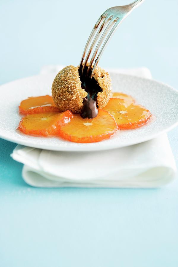 A Sliced Chocolate Dumplings On Candied Mandarins Photograph by Michael Wissing