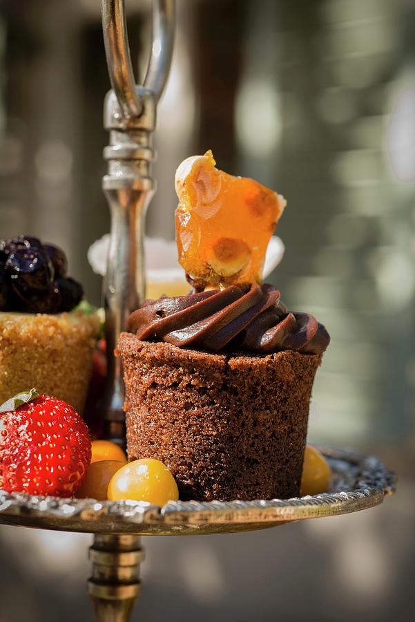A Small Chocolate Cake And Fruits On An tagre Photograph by Great Stock!
