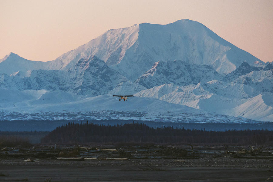 Sunset Photograph - A Small Plane Flies In Front Of Mt Foraker Of The Alaska Range A by Cavan Images