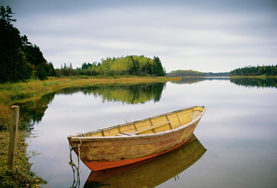 A Small Wooden Dory Or Rowing Boat by Mint Images - David Schultz