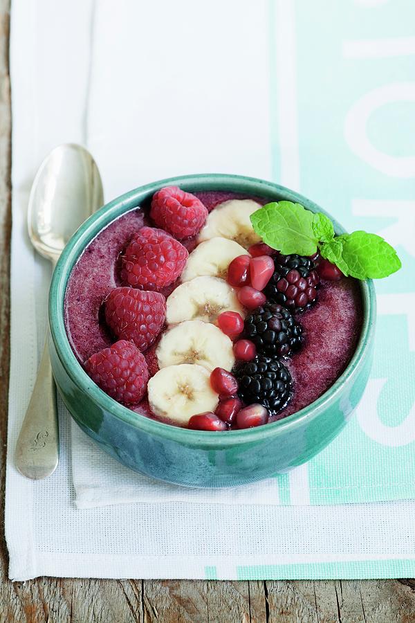 A Smoothie Bowl Made From Raspberries, Blackberries, Banana And Strawberries Garnished With Raspberries, Bananas, Blackberries And Pomegranate Seeds Photograph by Victoria Firmston