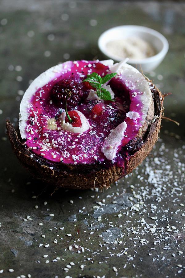 A Smoothie Bowl Served In Half A Coconut Photograph by Milly Kay