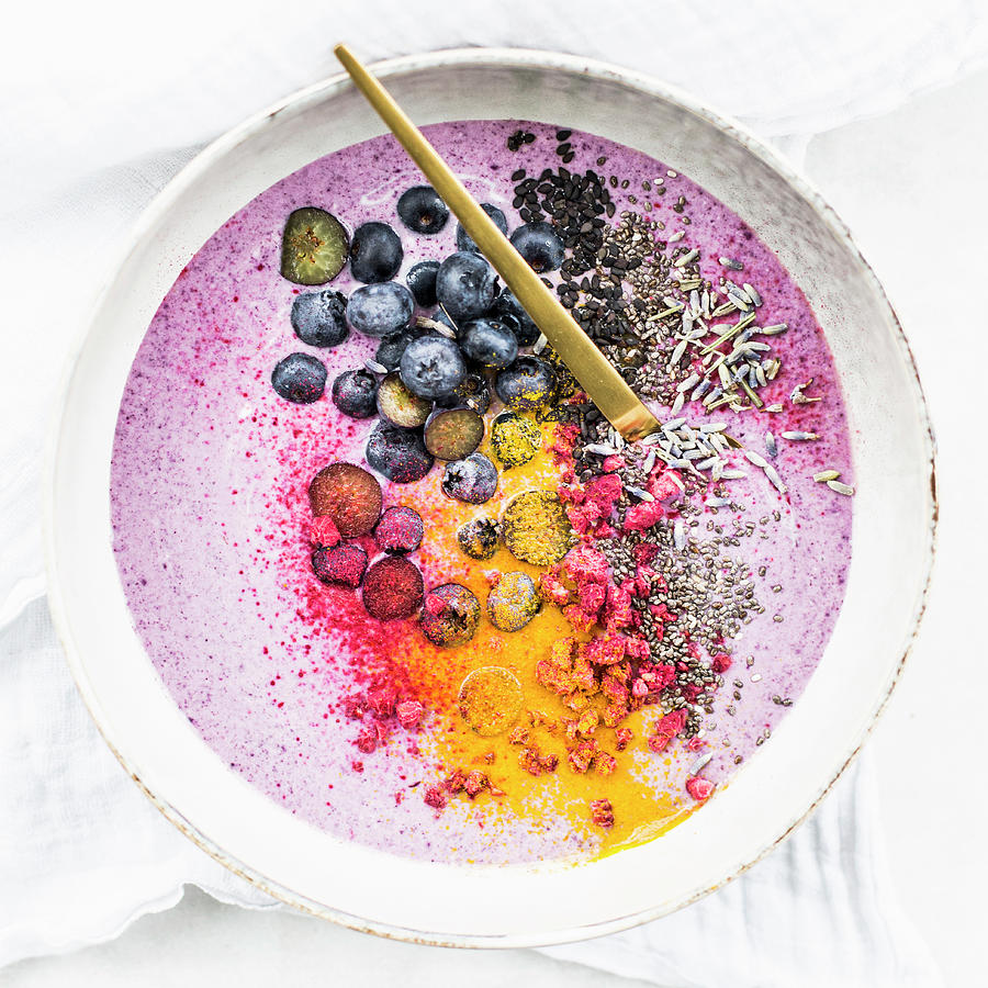A Smoothie Bowl With Berries, Turmeric, Chia Seeds, Black Sesame Seeds And Lavender Photograph by Theveggiekitchen