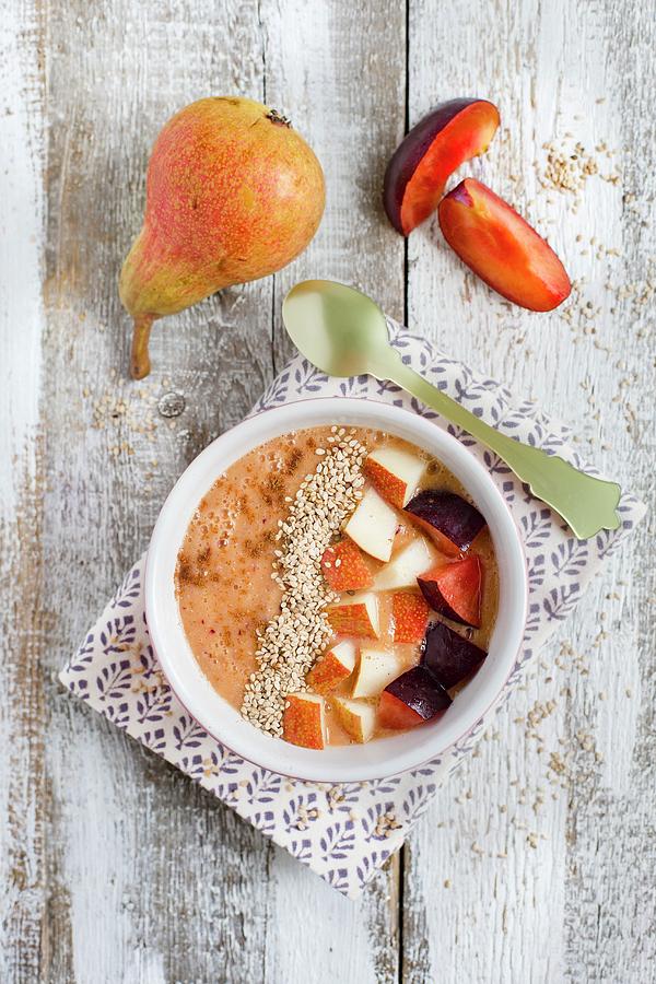 A Smoothie Bowl With Buckwheat Groats, Plum, Orange, Pear And Sesame Seeds Photograph by Tina Engel