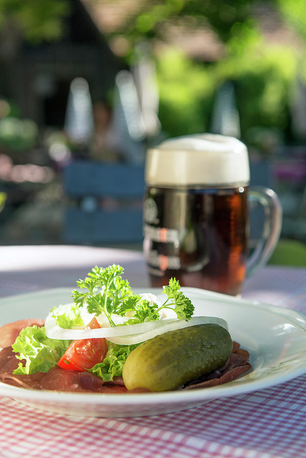 A Snack Of Ham, Gherkins And Beer On A Table Outside Photograph by Jalag / Michael Schinharl
