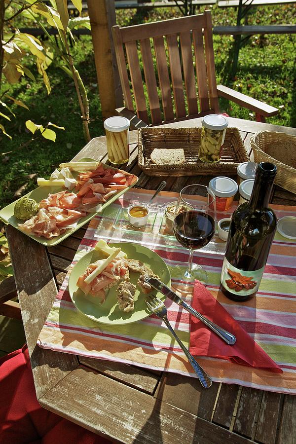 A Snack With Red Wine On A Garden Table Photograph by Herbert Lehmann
