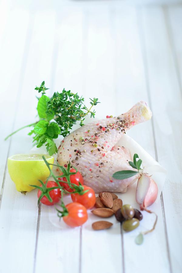 A Spiced Chicken Leg With Onion, Olives, Almonds, Cherry Tomatoes, Lemon And Herbs Photograph by Tanja Major