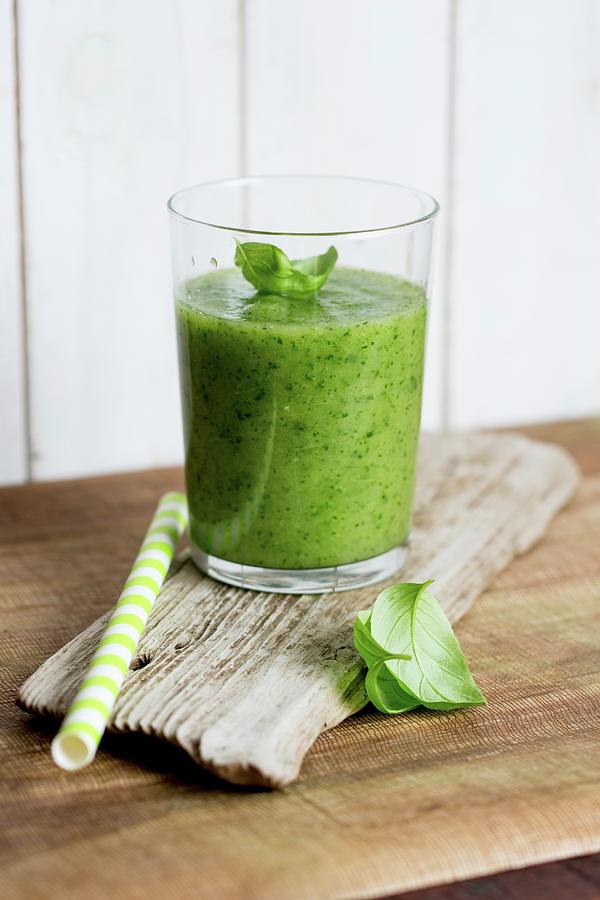 A Spinach And Pineapple Smoothie Photograph by Claudia Timmann