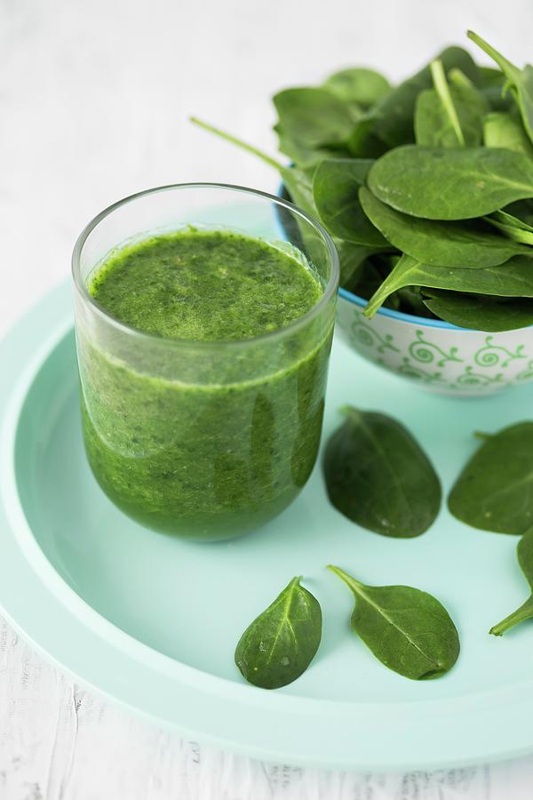 A Spinach Smoothie In A Glass With Fresh Spinach Photograph by Malgorzata Laniak