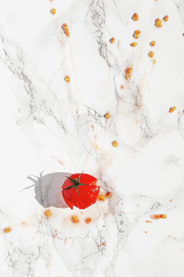 A Splattered Tomato On A Marble Surface Photograph by Olga Miltsova