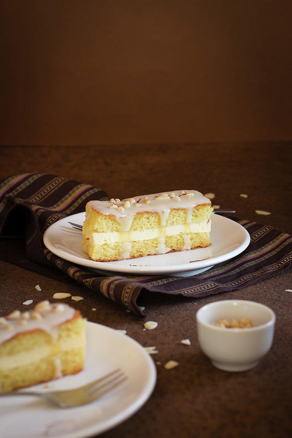 A Sponge Cake Slice With Cream Filling And Sugar Glaze Photograph by Alice Del Re