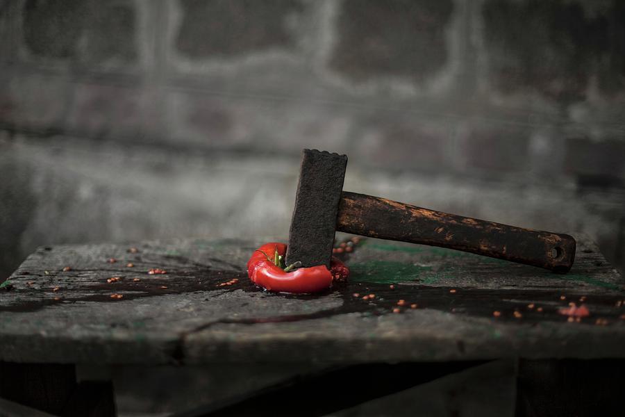 A Squashed Tomato With A Hammer On A Wooden Table Photograph by Nika Moskalenko