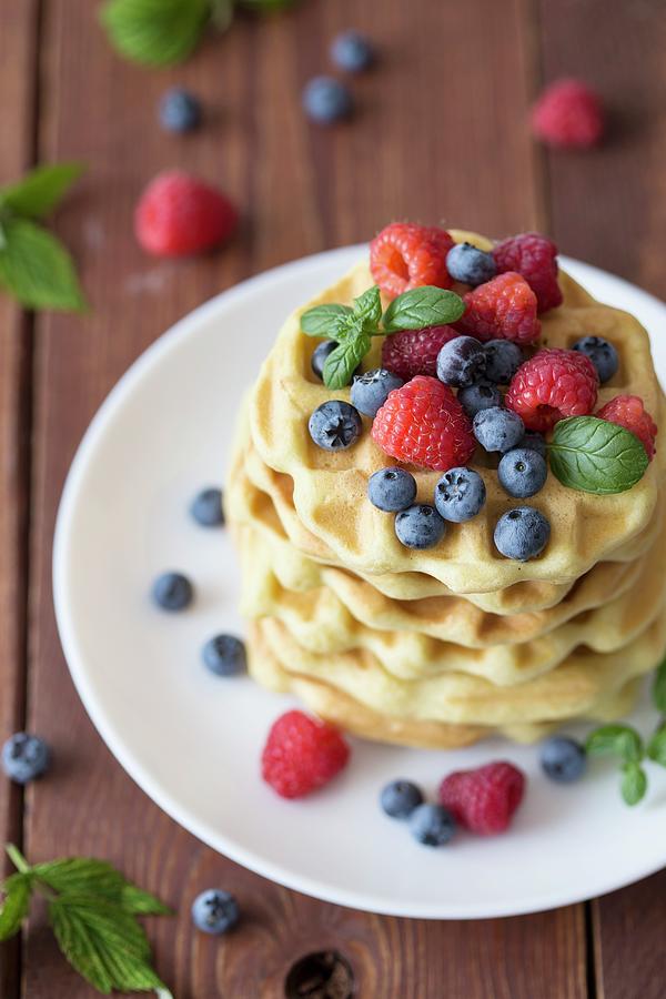 A Stack Of Belgian Waffles With Raspberries And Blueberries Photograph by Malgorzata Laniak