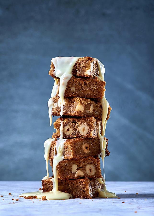 A Stack Of Blondies With Hazelnuts And White Chocolate Sauce Photograph by Great Stock!