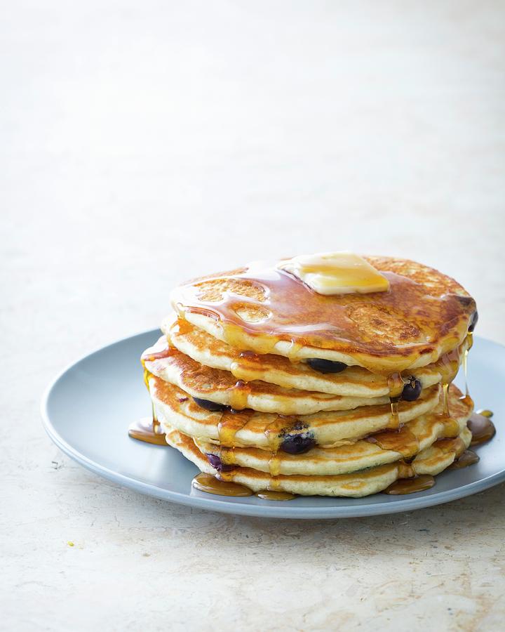 A Stack Of Blueberry Pancakes On A Plate With Maple Syrup And Butter Photograph by Keller & Keller Photography