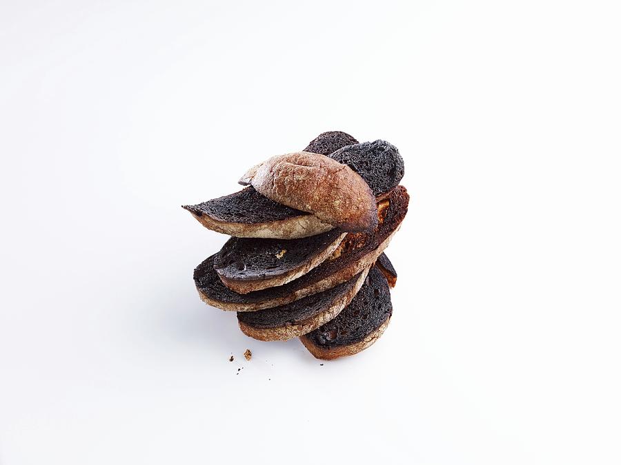 A Stack Of Charred Bread Slices In Front Of White Background Photograph by Studio R. Schmitz