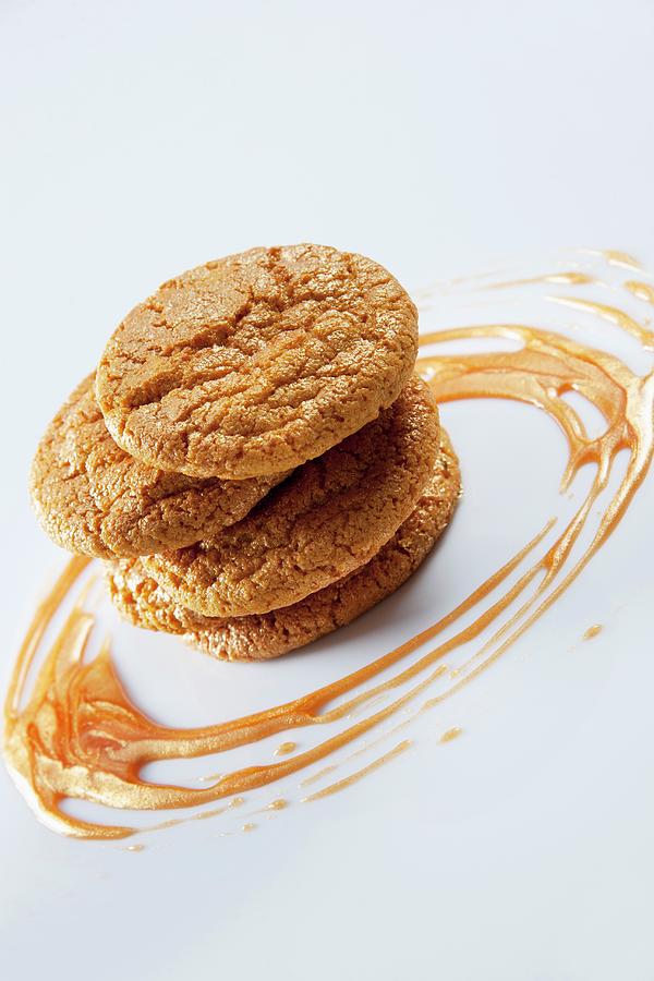 A Stack Of Cookies With Caramel Sauce Photograph by Christophe Madamour