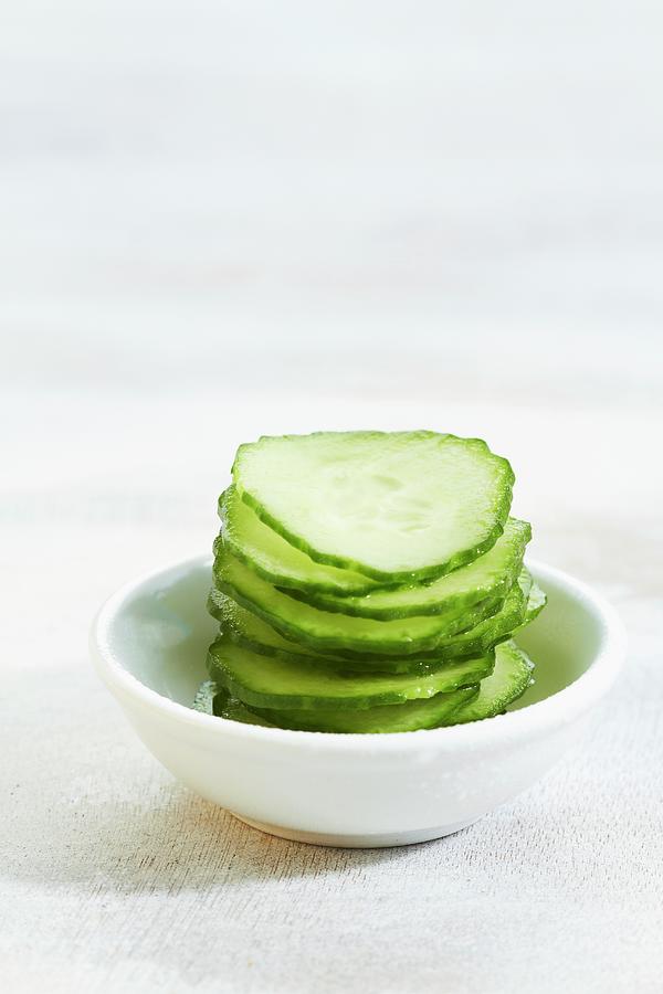 A Stack Of Cucumber Slice On A Bowl Photograph by Miriam Rapado