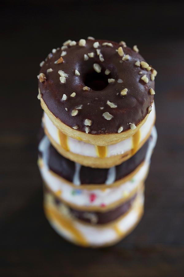 A Stack Of Doughnuts With Different Glazes Photograph by Nicole Godt