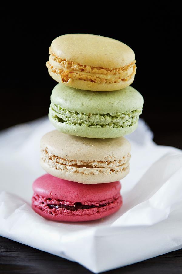 A Stack Of Four Different Coloured Macaroons Photograph by Catja Vedder
