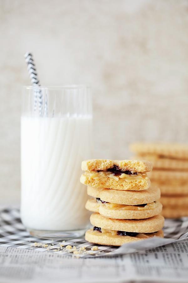 A Stack Of Jam And Cream Biscuits With A Glass Of Milk Photograph by Jane Saunders