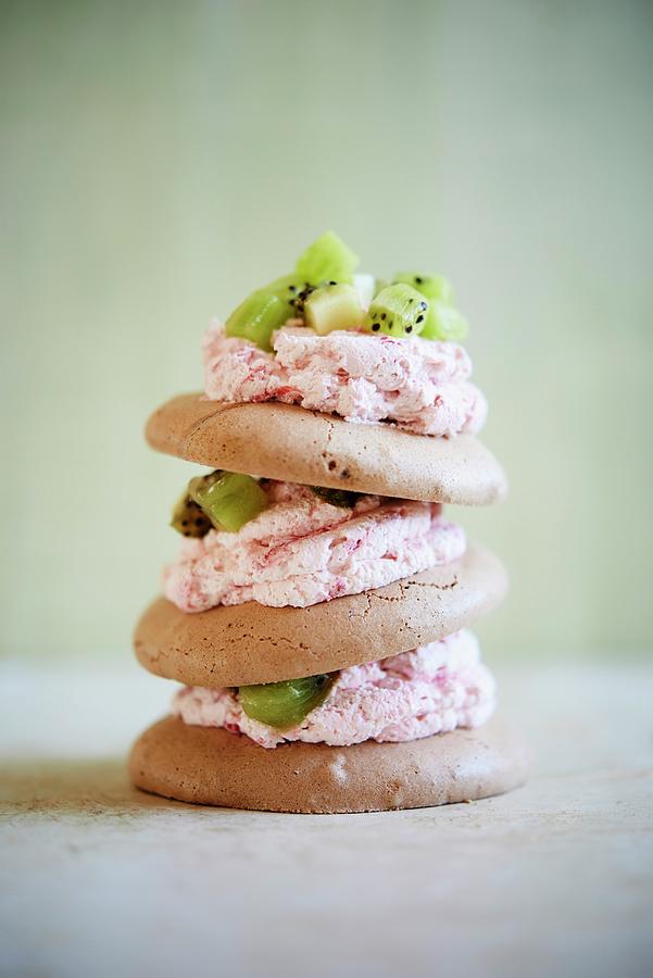 A Stack Of Meringue Biscuits With Strawberry Cream And Kiwis Photograph by Greg Rannells