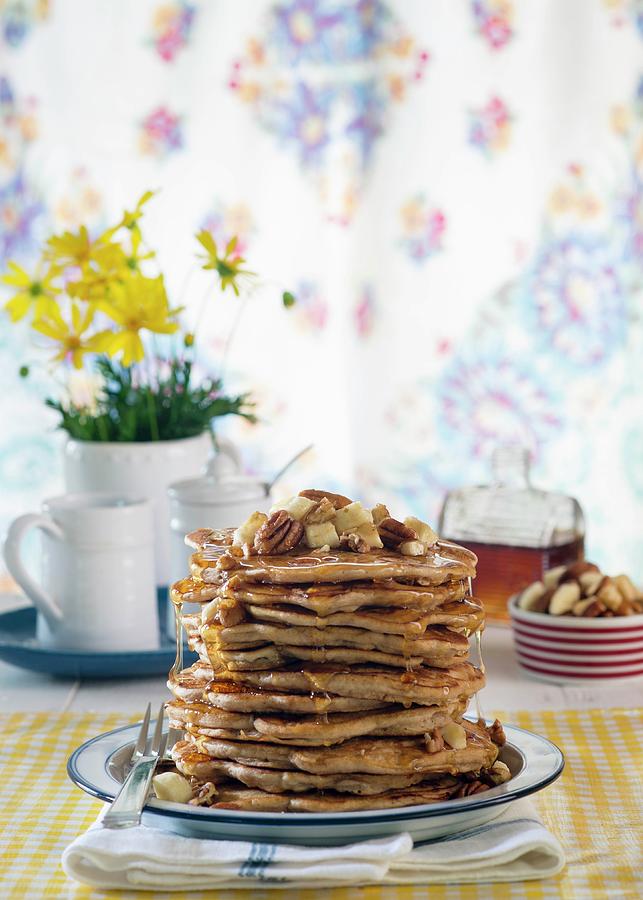 A Stack Of Pancakes With Banana And Pecan Nuts Photograph by Farrell Scott