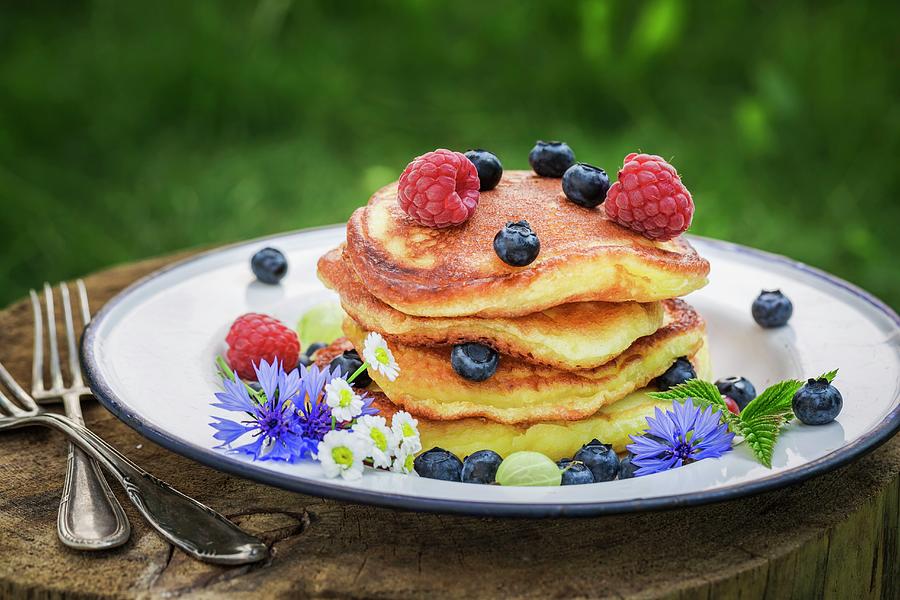 A Stack Of Pancakes With Fresh Berries And Maple Syrup Photograph by Shaiith