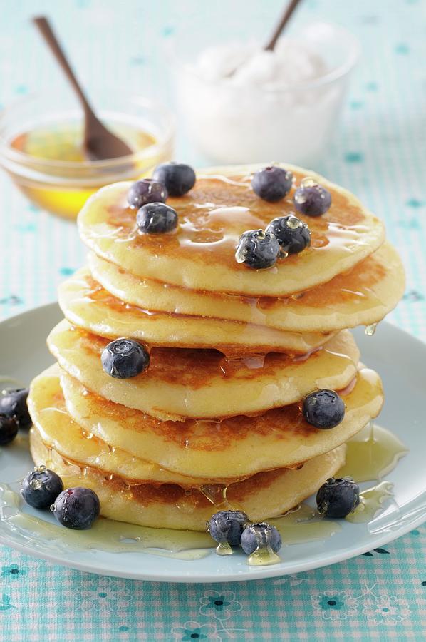 A Stack Of Pancakes With Honey And Blueberries Photograph by Jean-christophe Riou