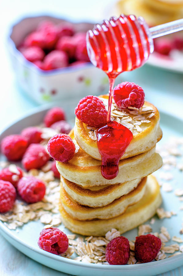 A Stack Of Pancakes With Raspberries And Raspberry Sauce Photograph by Gorobina