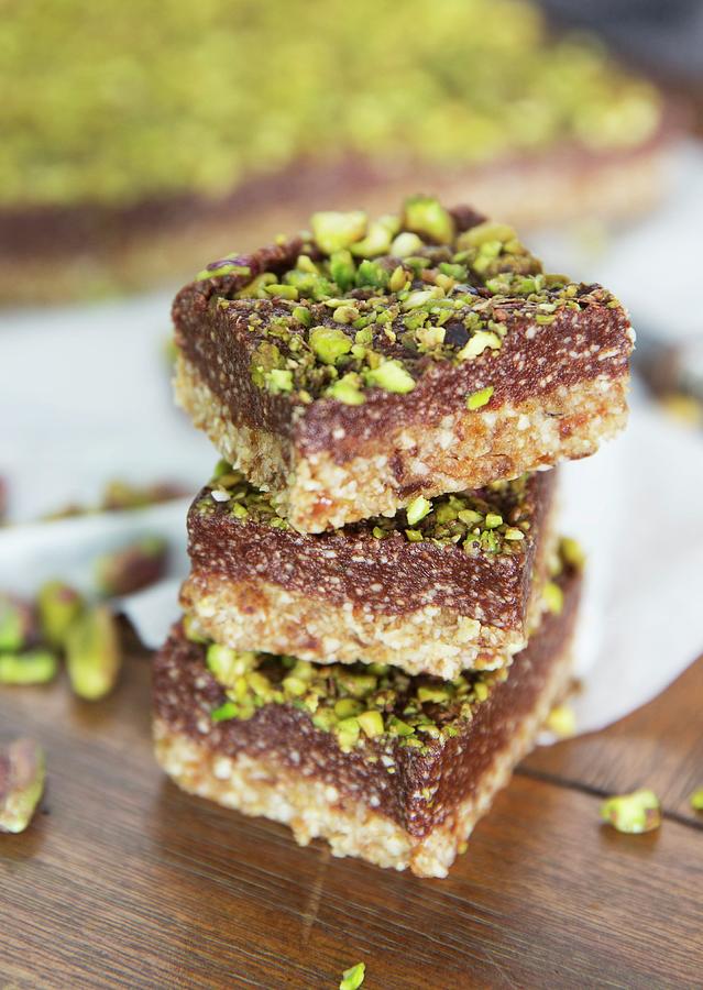 A Stack Of Pistachio And Chocolate Slices Photograph by Elle Brooks