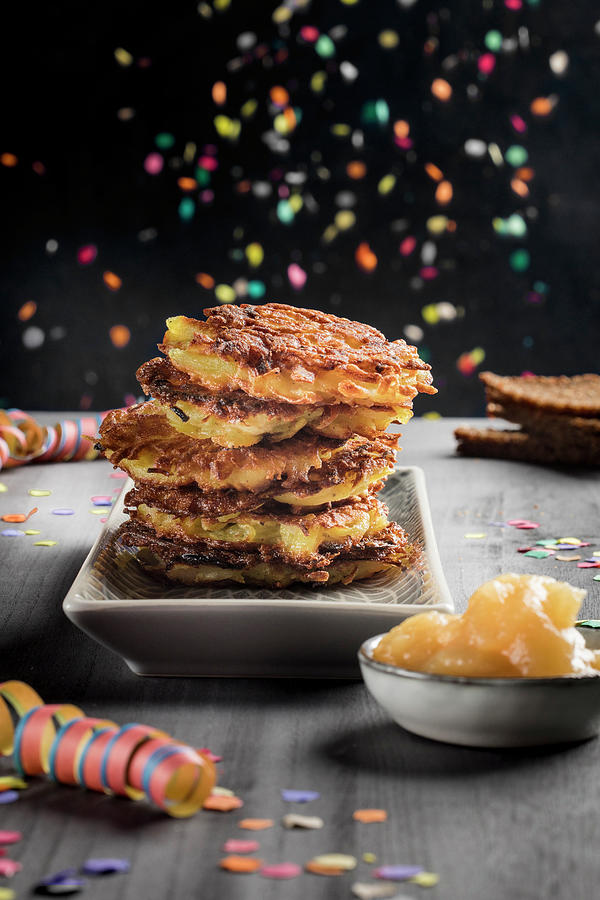 A Stack Of Potato Fritters With Apple Sauce And Carnival Decorations Photograph by Jennifer Braun