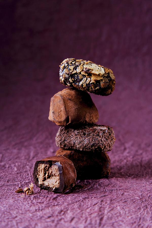 A Stack Of Pralines On A Purple Surface Photograph by Julian Winkhaus