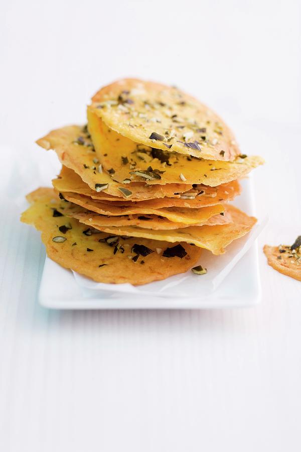 A Stack Of Pumpkin Crisps With Chopped Pumpkin Seeds Photograph by Michael Wissing