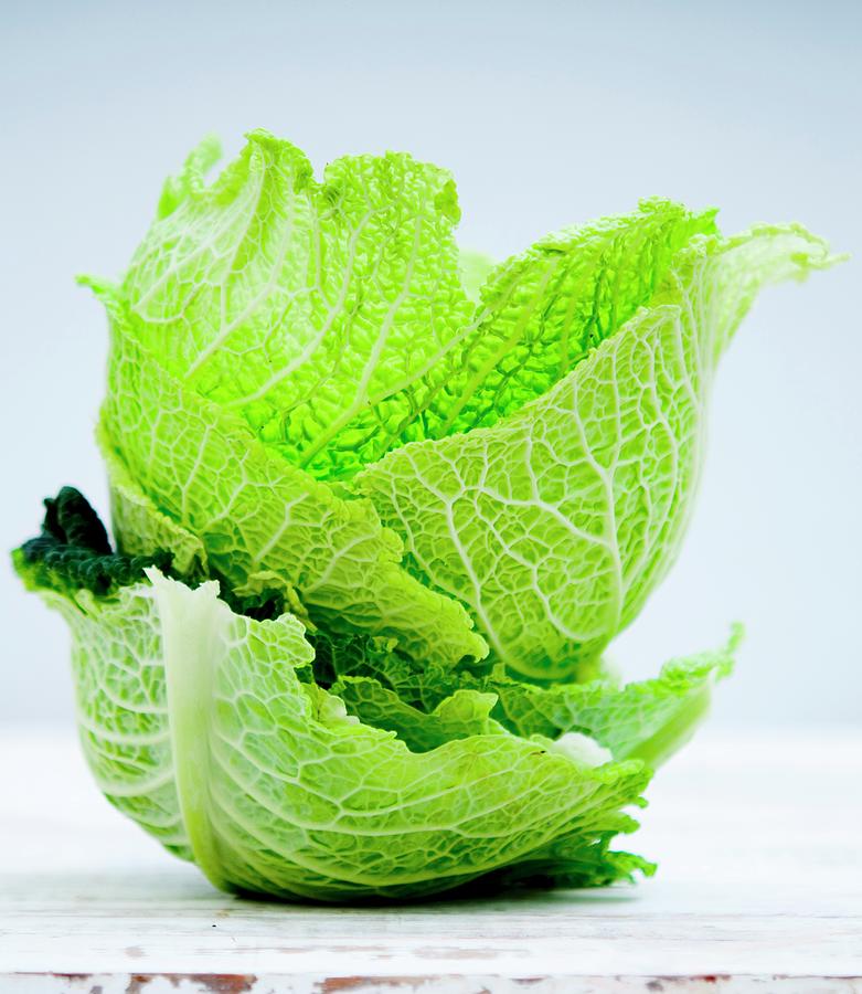 A Stack Of Savoy Cabbage Leaves Photograph by Udo Einenkel