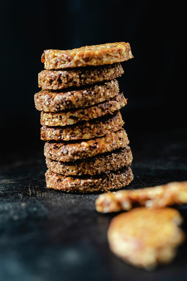 A Stack Of Spiced Biscuits With Walnuts, Dates And Coconut Flakes Photograph by Elisabeth Von Plnitz-eisfeld